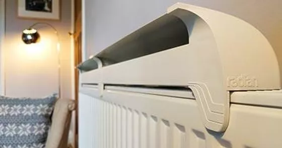 a radfan medium 3 heater on top of a radiator to improve efficiency and performance a radfan medium 3 heater on top of a radiator to improve efficiency and performance