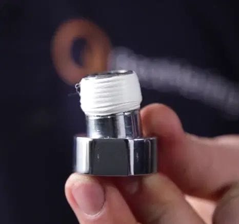 A replacement radiator valve tail that has been wrapped in PTFE tape to make a watertight seal