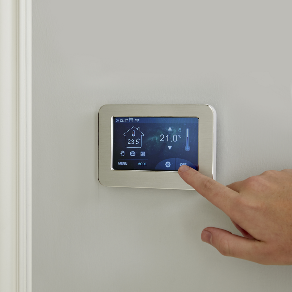 A milano compact thermostat being used on a wall