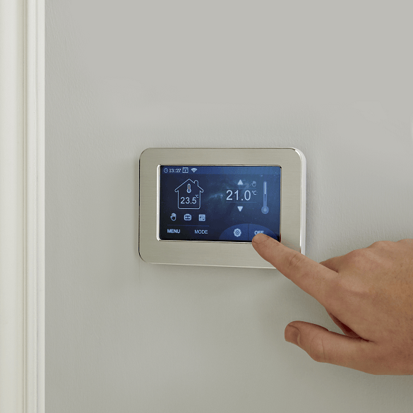 A milano compact thermostat being used on a wall