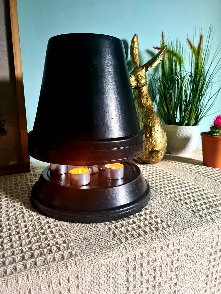 a black terracotta heater warming a space without the need for central heating