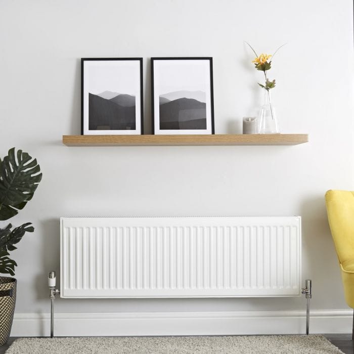 Plumbed radiator cutout image of a valve and radiator a type 21 convector radiator with a shelf above it in a sitting room