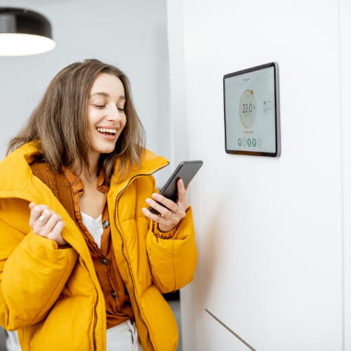 woman turning the heating on