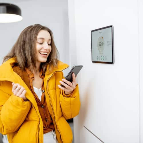 woman turning the heating on