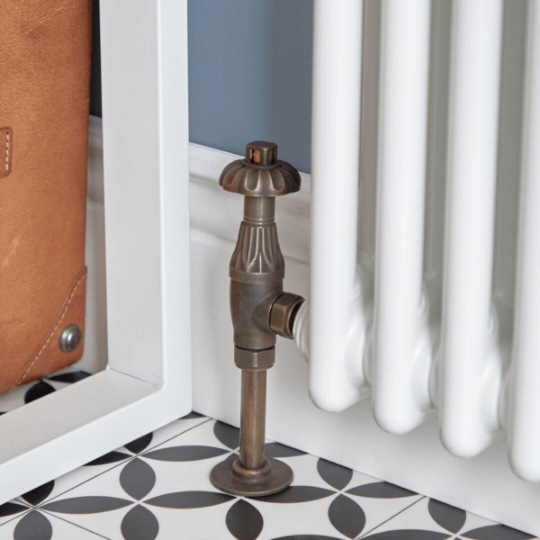 close up of a traditional radiator valve on a white traditional radiator
