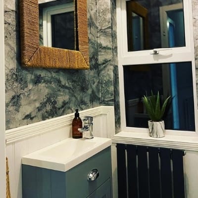 small black radiator in a cloakroom