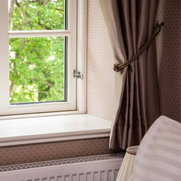 short curtains hanging over a radiator