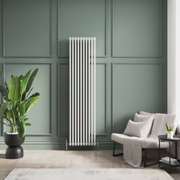 white vertical column radiator in a green living room