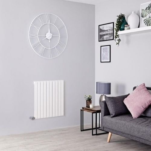 milano capri wall mounted electric heater in a grey living room