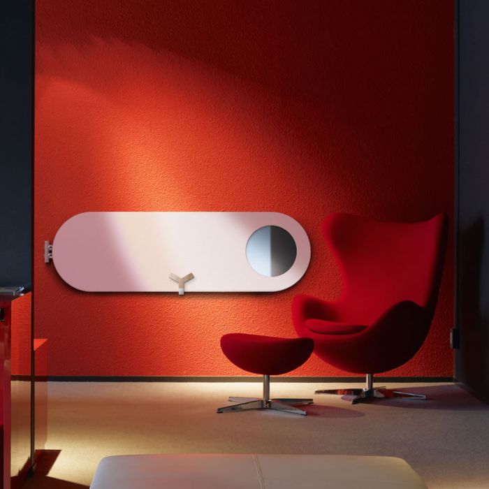 A picture of a Lazzarini Vulcano mirrored radiator in a red office space
