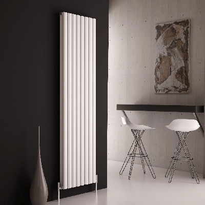 A tall white vertical radiator on a black wall
