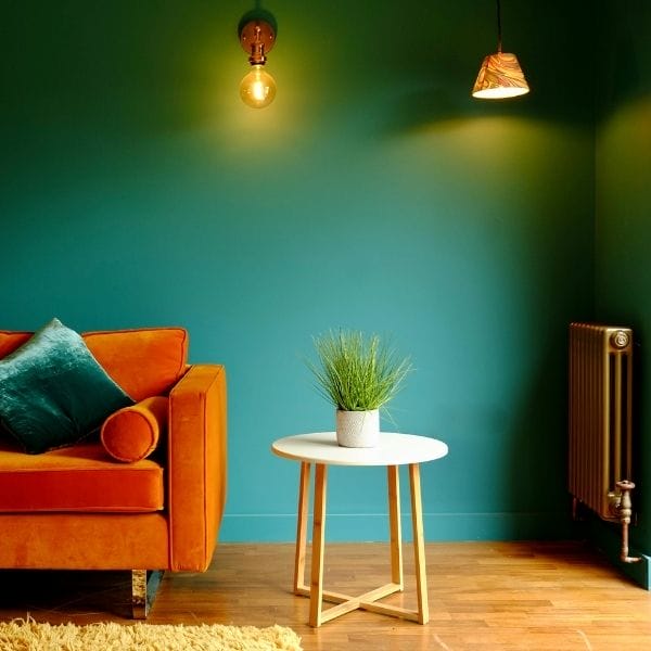 bronze radiator next to an orange sofa
