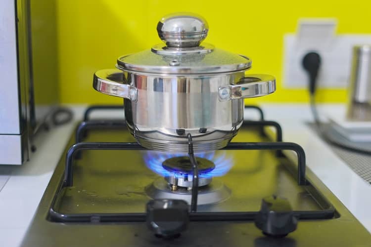 a saucepan on a gas hob with the lid on