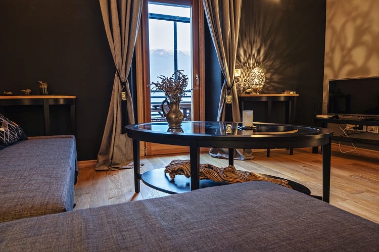 a warm bohemian living space with dark features and attractive furniture