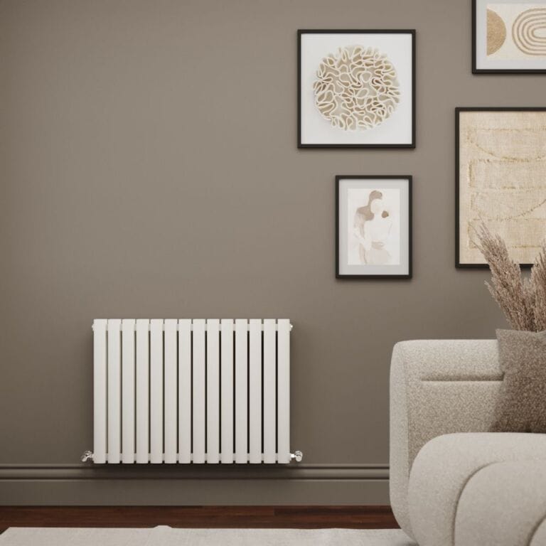 Milano Aruba Ayre aluminium white horizontal designer double panel radiator on light brown wall in modern interior with framed artwork and light coloured settee nearby