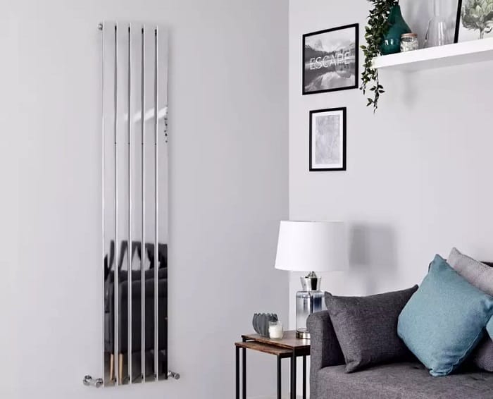 Milano Alpha chrome vertical radiator a chrome Milano Alpha designer radiator on a wall in a sitting room