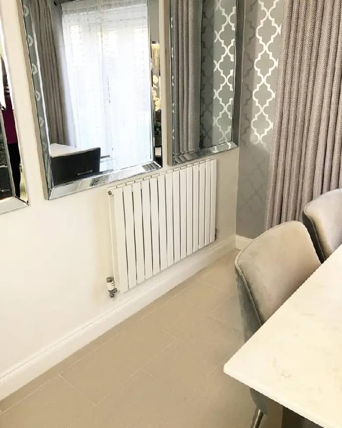 A Milano Alpha Designer radiator from BestHeating on a white wall.
