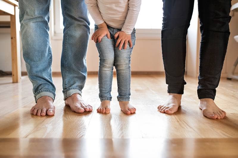 family barefoot on a wooden floor