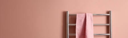 heated towel rail with a pink towel on it