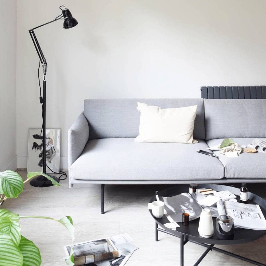 Milano Alpha designer radiator behind a modern sofa Milano Alpha designer radiator behind a modern sofa