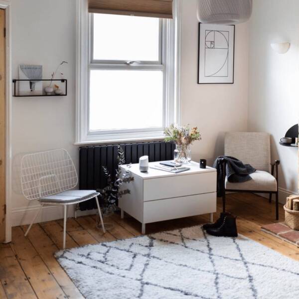 Milano Alpha anthracite radiator in a minimal living room