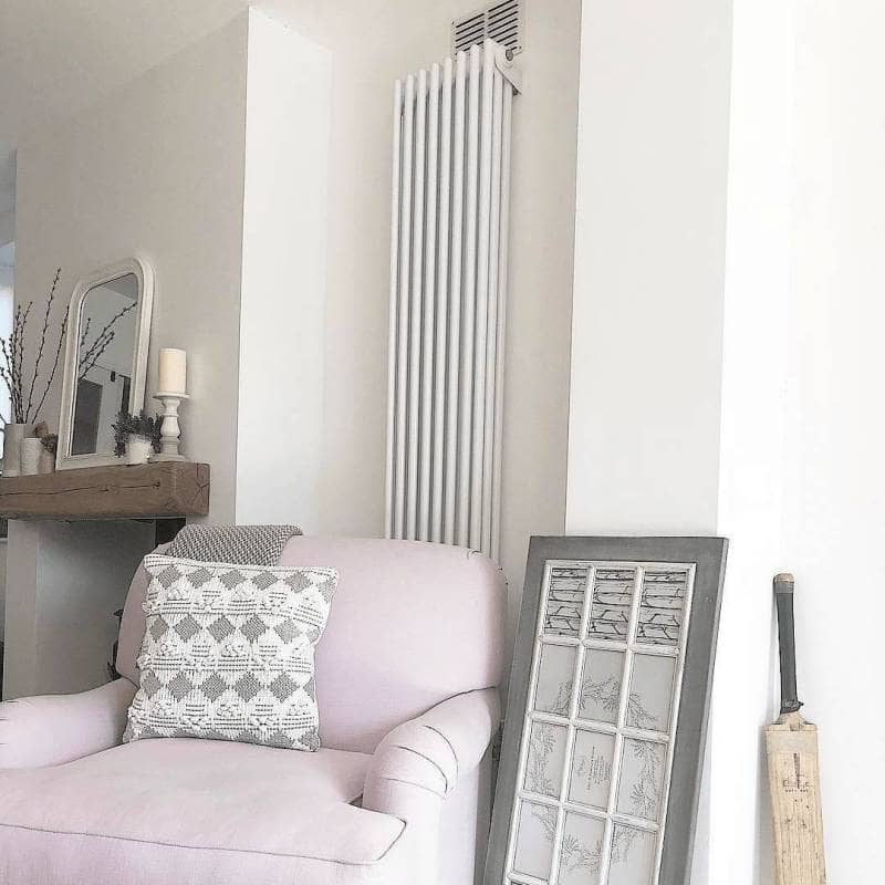 Vertical Milano Windsor radiator behind a pink sofa