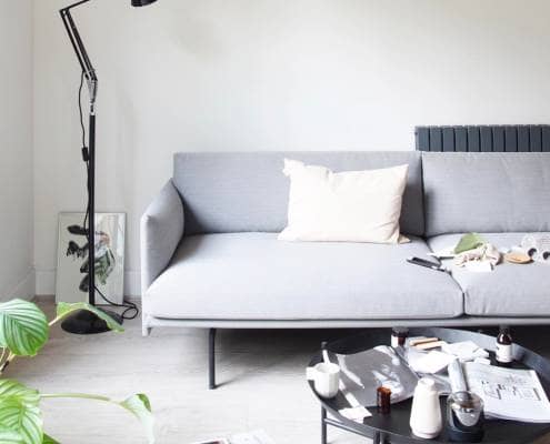 Milano Alpha designer radiator behind a modern sofa
