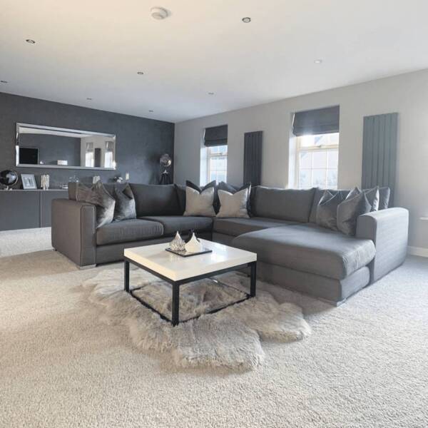 Two Milano Alpha radiators in a grey living room