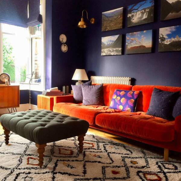 Milano Windsor column radiator behind an orange sofa