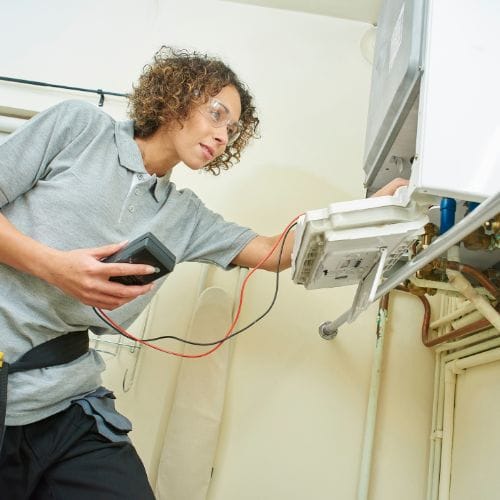 plumber servicing a boiler
