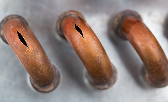 burst copper pipes from the cold, closeup burst copper pipes from the cold, closeup