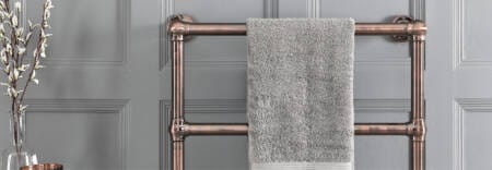 bronze heated towel rail in a bathroom