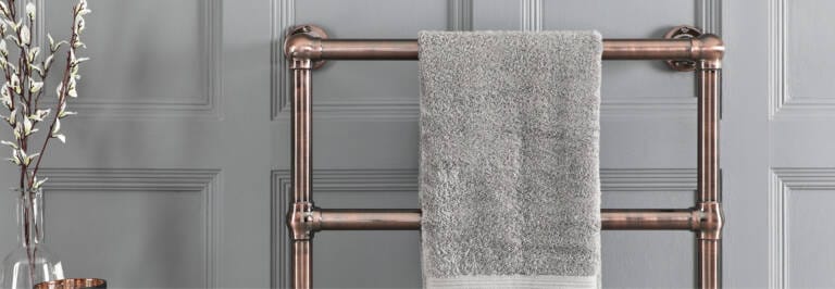 bronze heated towel rail in a bathroom
