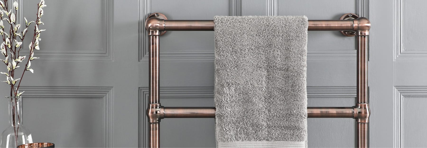 bronze heated towel rail in a bathroom