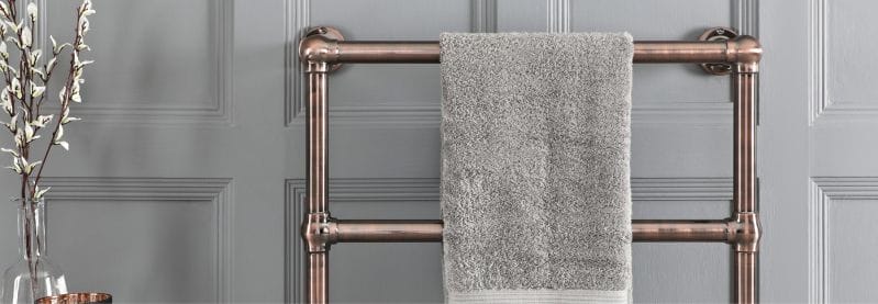 bronze heated towel rail in a bathroom