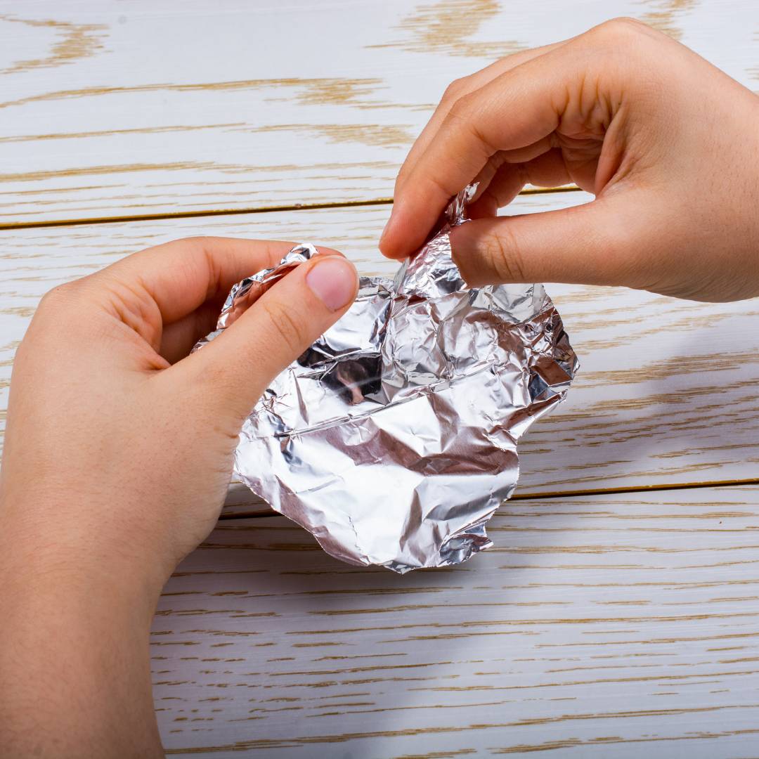 hands holding tinfoil