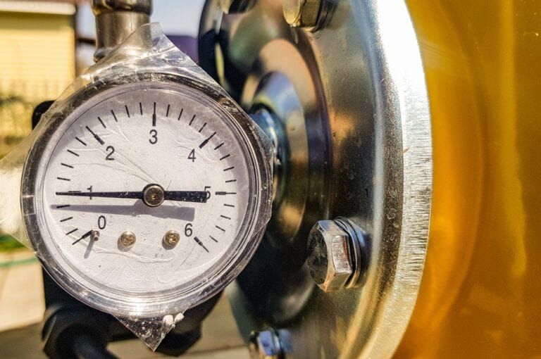 Close-up image of traditional pressure gauge on gas boiler