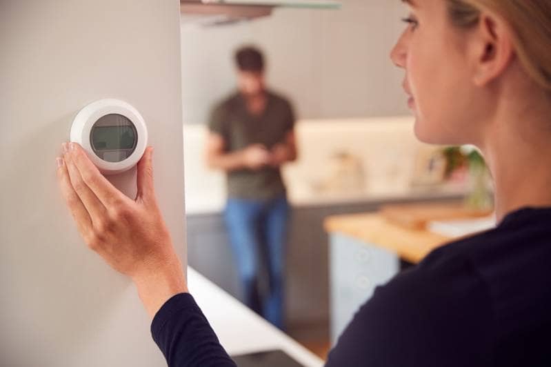woman using a thermostat