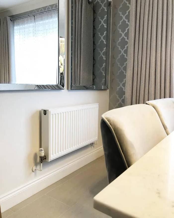 A convector radiator on a white wall. 