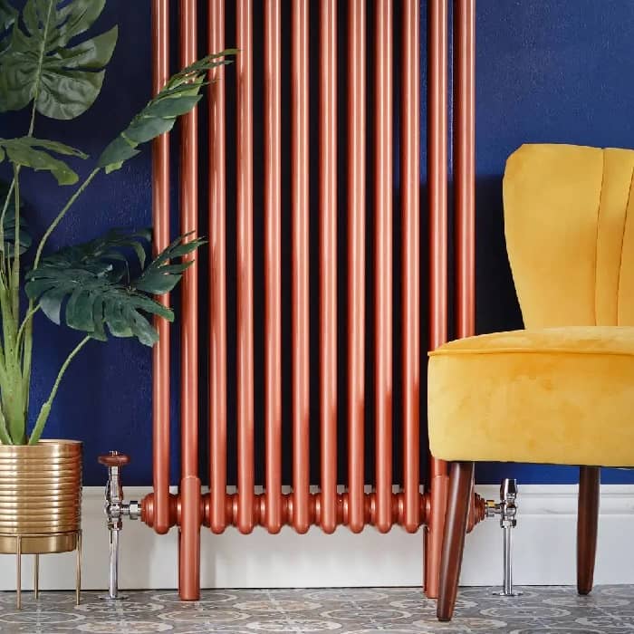 Copper column radiator on a blue wall