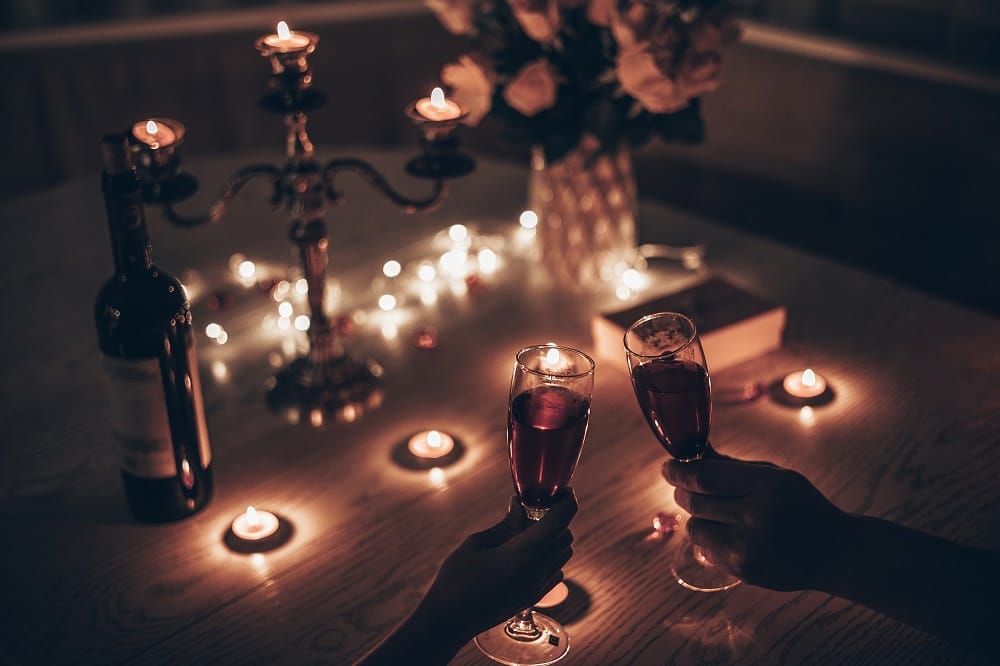 ECOSO Luan black electric portable oil filled radiator Couple toasting with a pair of red wine glasses on candlelit table