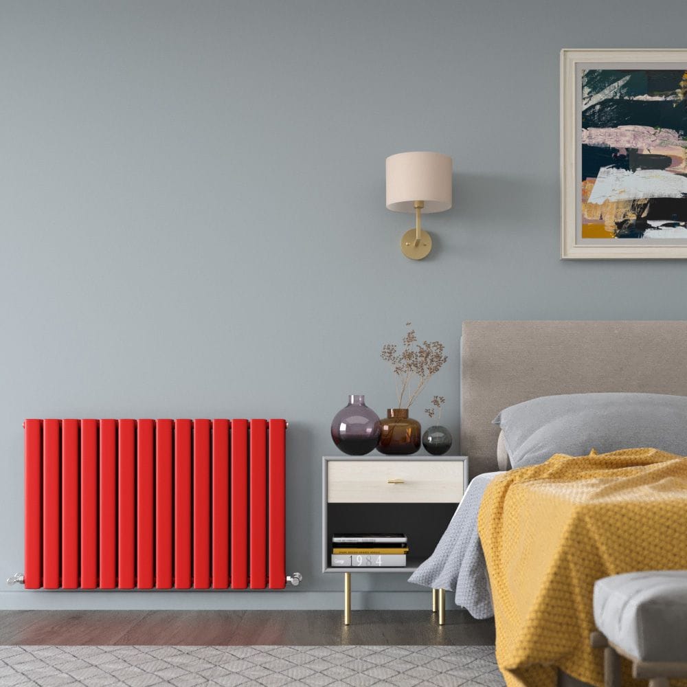 Milano Alpha red horizontal flat double panel designer radiator on light blue wall nearby bedside table and bed beneath artwork and light fitting