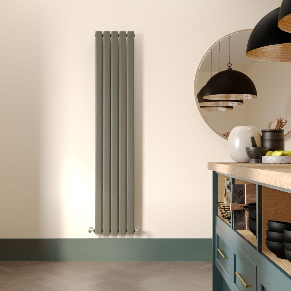 Milano Alpha sage leaf green vertical flat panel designer radiator on cream wall next to large mirror and modern worktop