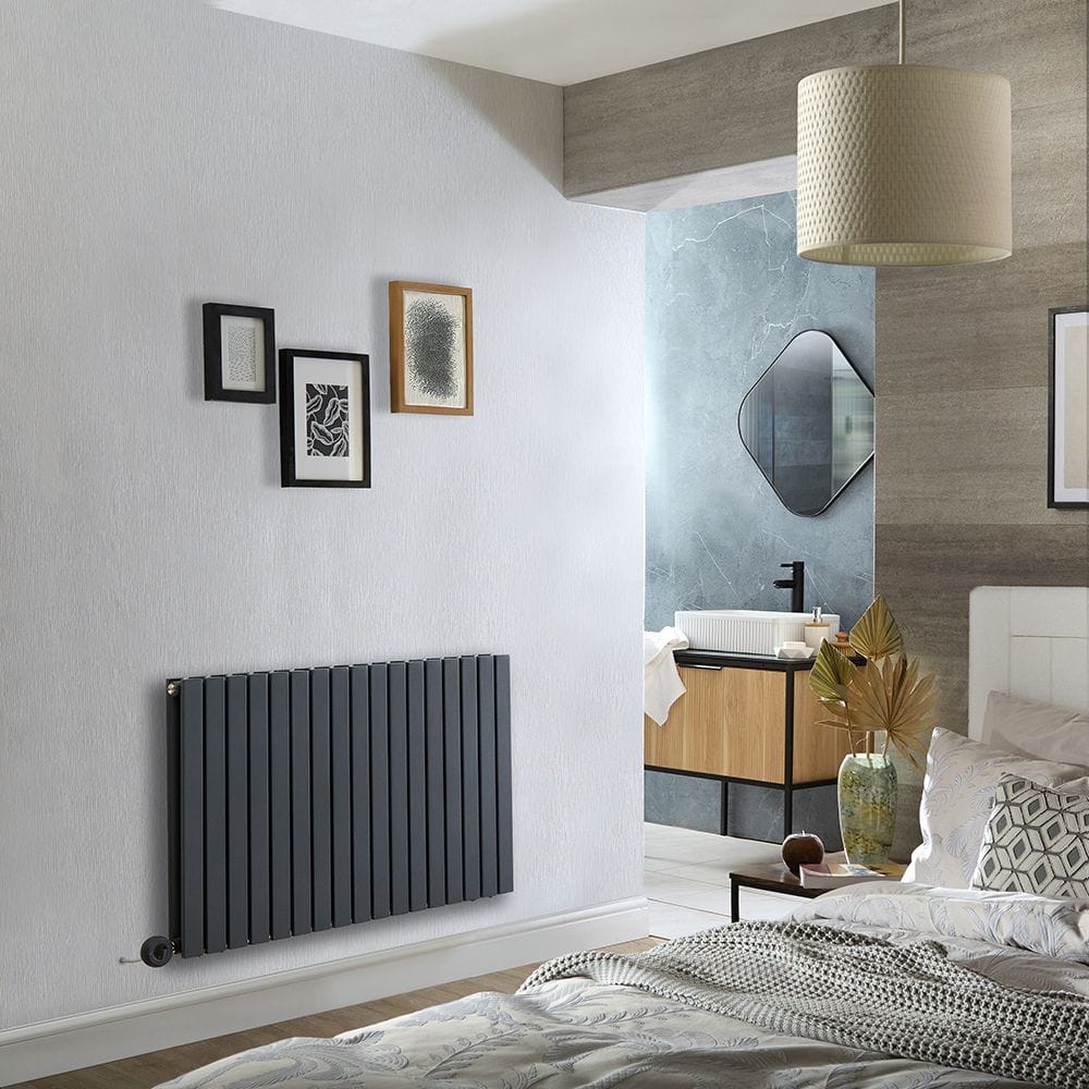 Milano x ECOSO Capri electric anthracite horizontal designer radiator on light wall beneath three pictures in busy modern interior setting