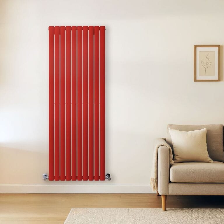 Milano Aruba red vertical double panel designer radiator on light wall nearby light grey settee with cushion underneath framed picture