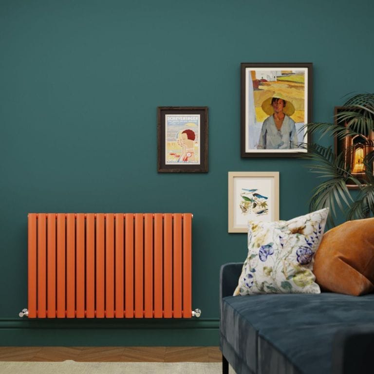 Milano Aruba orange horizontal single panel designer radiator on green wall nearby multiple framed art pictures and blue settee