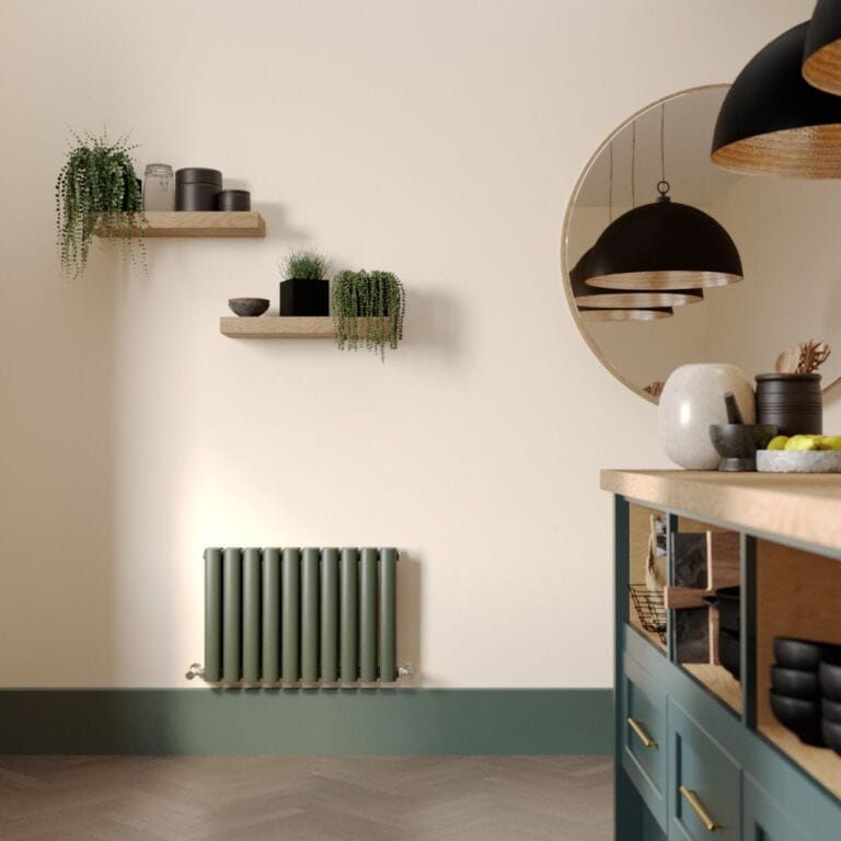 Milano Aruba evergreen horizontal designer radiator on cream wall in modern interior beneath shelves with houseplants and large mirror and modern storage unit