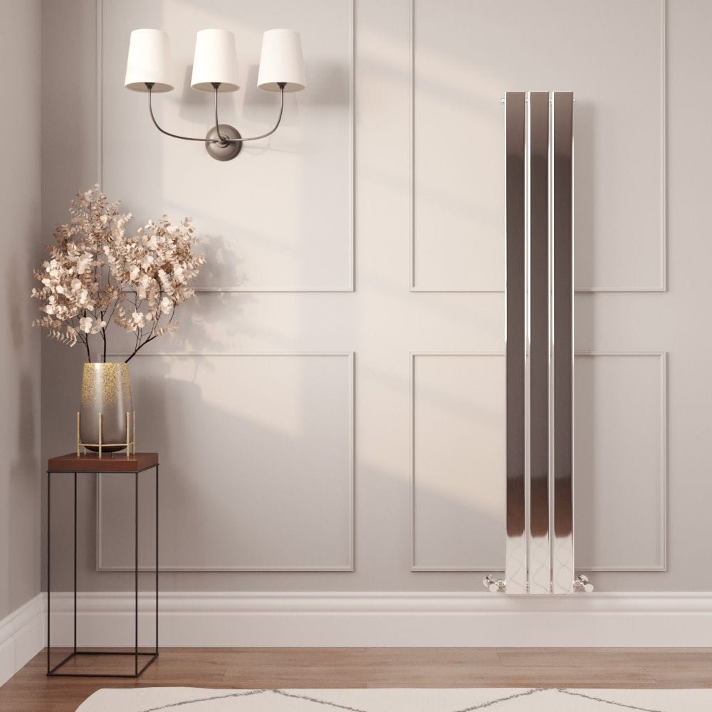 Milano Alpha chrome vertical flat panel designer radiator on light wall in modern interior nearby a tall table with vase