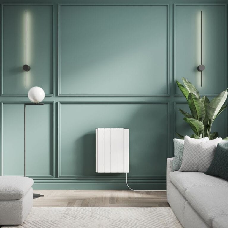 ECOSO Tuc white ceramic core plug in smart electric heater on green background in modern interior near grey settee, rug and footstool along with houseplant and modern light fittings