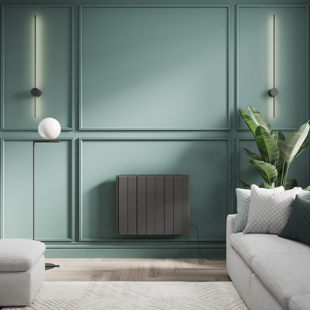 ECOSO Tuc anthracite ceramic core plug-in smart electric heater ECOSO Tuc anthracite ceramic core plug-in smart electric heater on green wall next to large plant and settee